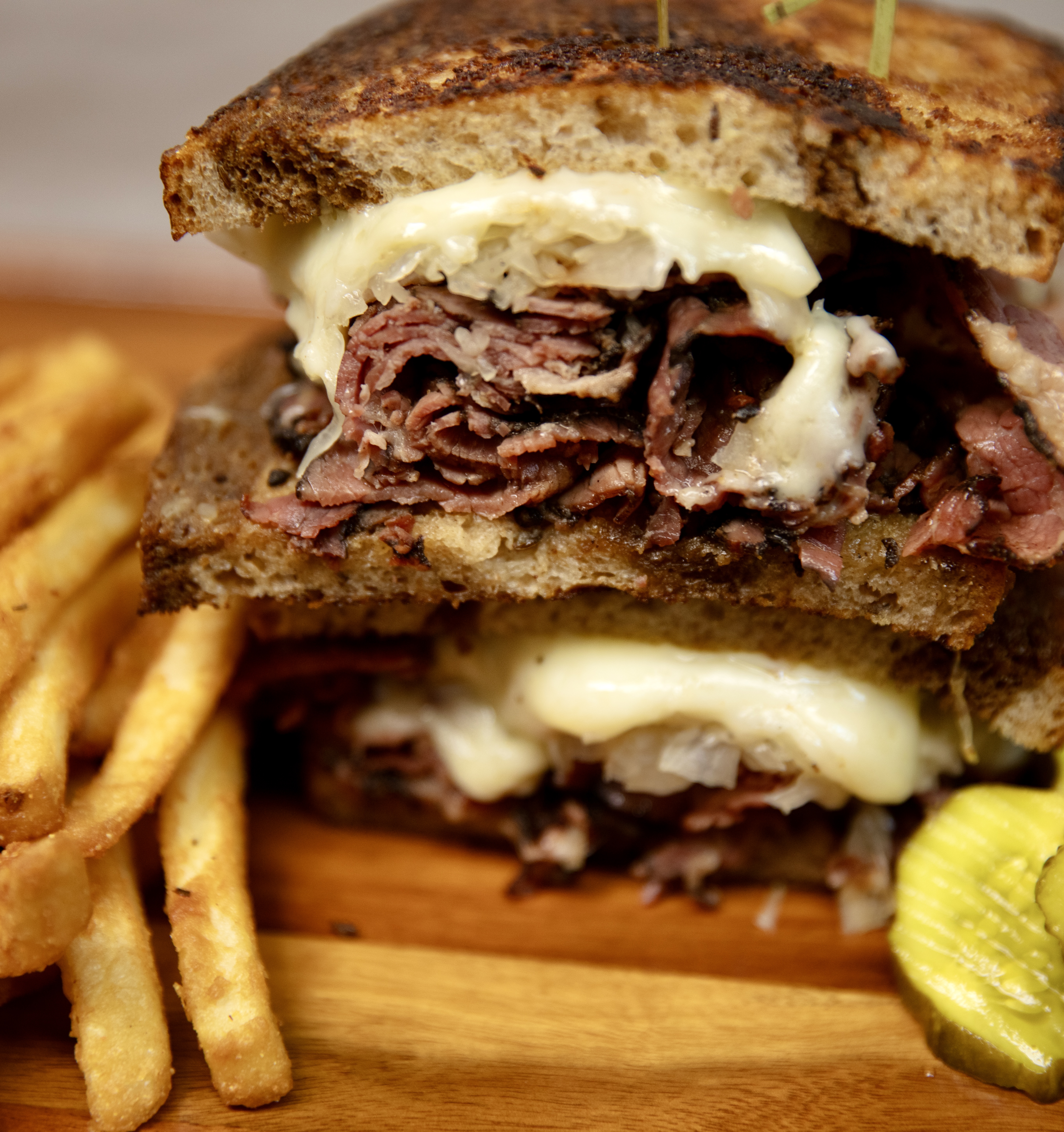 A.C.K.'s Pastrami Reuben panini with fries and pickle