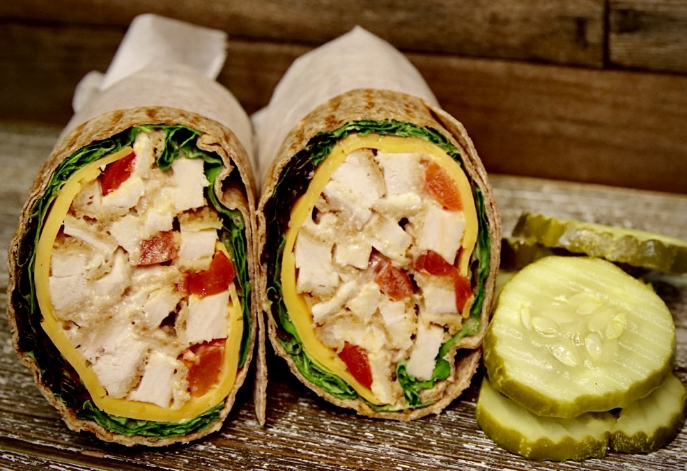 Greek chicken wrap sliced in half